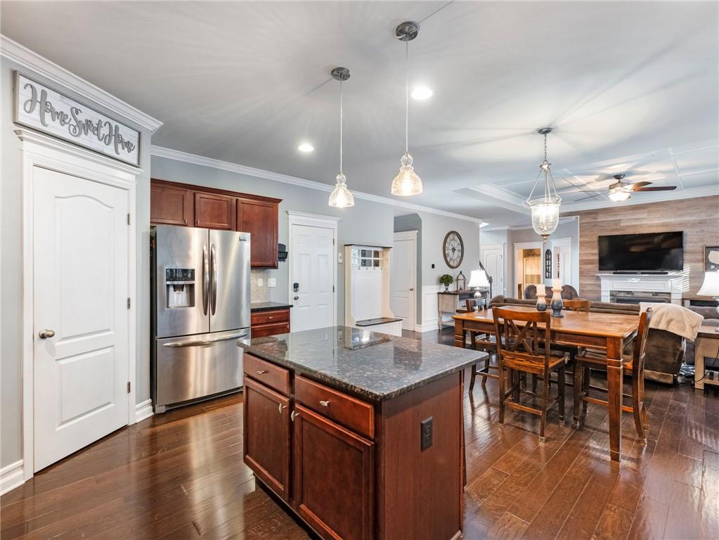 2939 Estate View Court Dacula, GA 30019 - Photo 20 of 73 a kitchen with stainless steel appliances granite countertop a refrigerator a stove a sink a dining table and chairs with wooden floor
