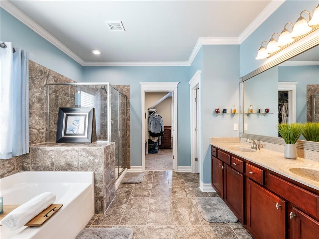 2939 Estate View Court Dacula, GA 30019 - Photo 29 of 73 a spacious bathroom with a tub sink and mirror