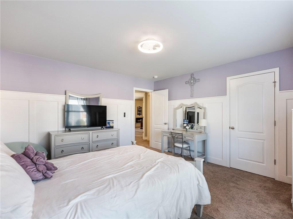 2939 Estate View Court Dacula, GA 30019 - Photo 36 of 73 a bedroom with a bed and a flat screen tv