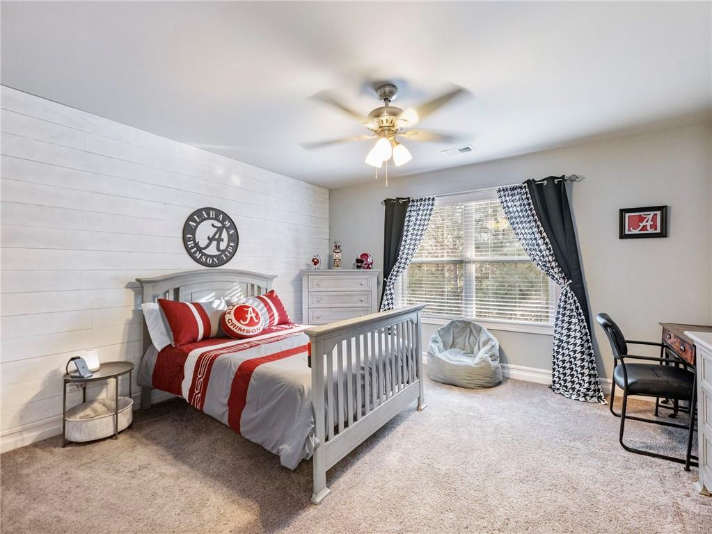 2939 Estate View Court Dacula, GA 30019 - Photo 39 of 73 a bedroom with a bed and a chandelier