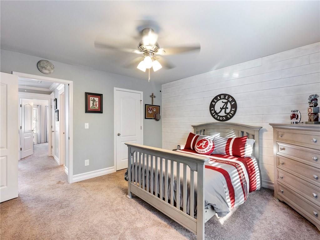 2939 Estate View Court Dacula, GA 30019 - Photo 40 of 73 a bedroom with a bed and a chandelier