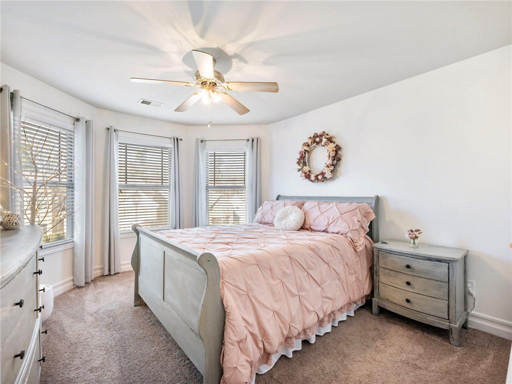 2939 Estate View Court Dacula, GA 30019 - Photo 42 of 73 a spacious bedroom with a bed and a chandelier