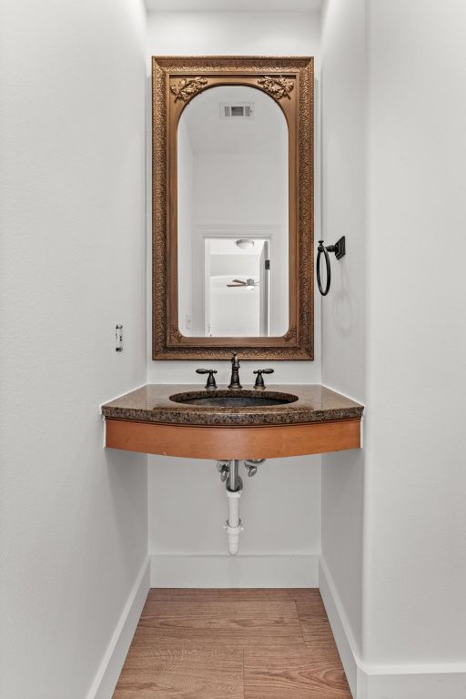 14000 Saskatchewan Drive Austin, TX 78734 - Photo 13 of 27 a bathroom with a sink and a mirror