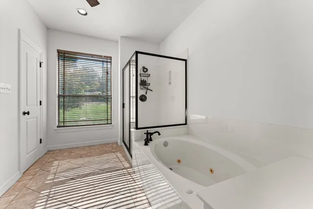 a bathroom with a bathtub and a shower