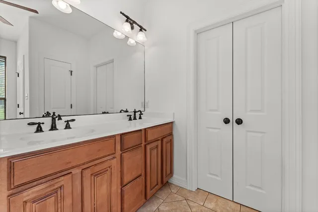 a bathroom with a double vanity sink and a mirror