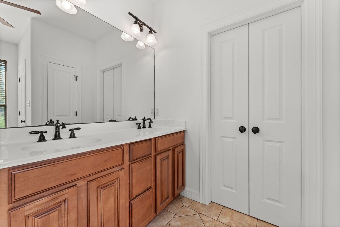 14000 Saskatchewan Drive Austin, TX 78734 - Photo 17 of 27 a bathroom with a double vanity sink and a mirror