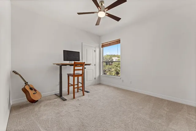 a view of a livingroom with furniture and a ceiling fan