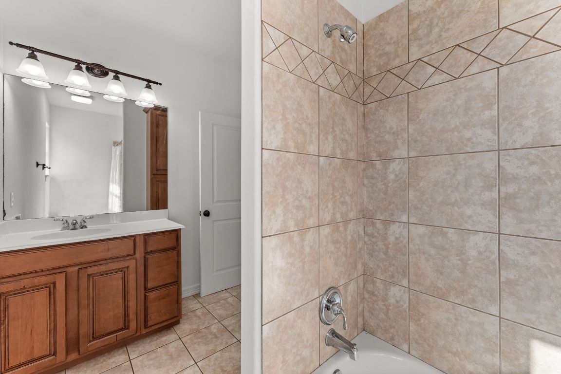 14000 Saskatchewan Drive Austin, TX 78734 - Photo 19 of 27 a bathroom with a granite countertop sink mirror and