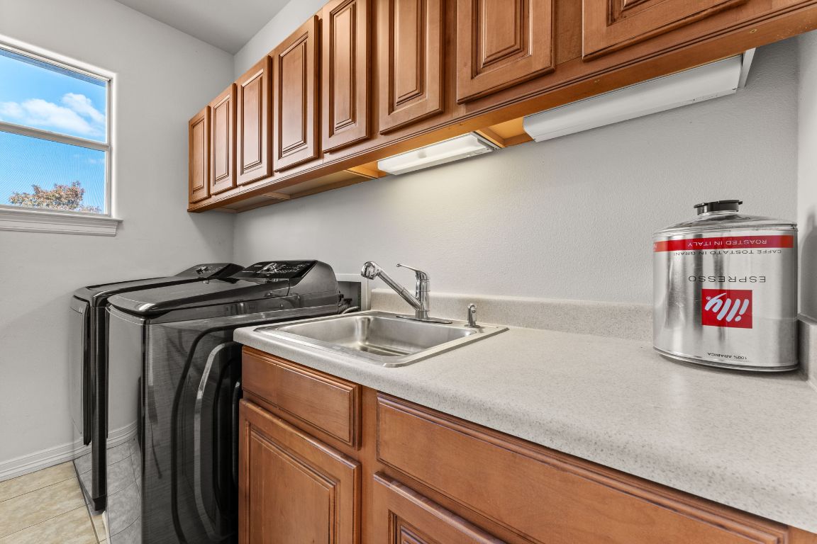 14000 Saskatchewan Drive Austin, TX 78734 - Photo 22 of 27 a utility room with stainless steel appliances and cabinets
