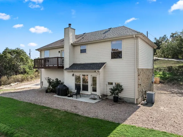 a view of a house with backyard and sitting area
