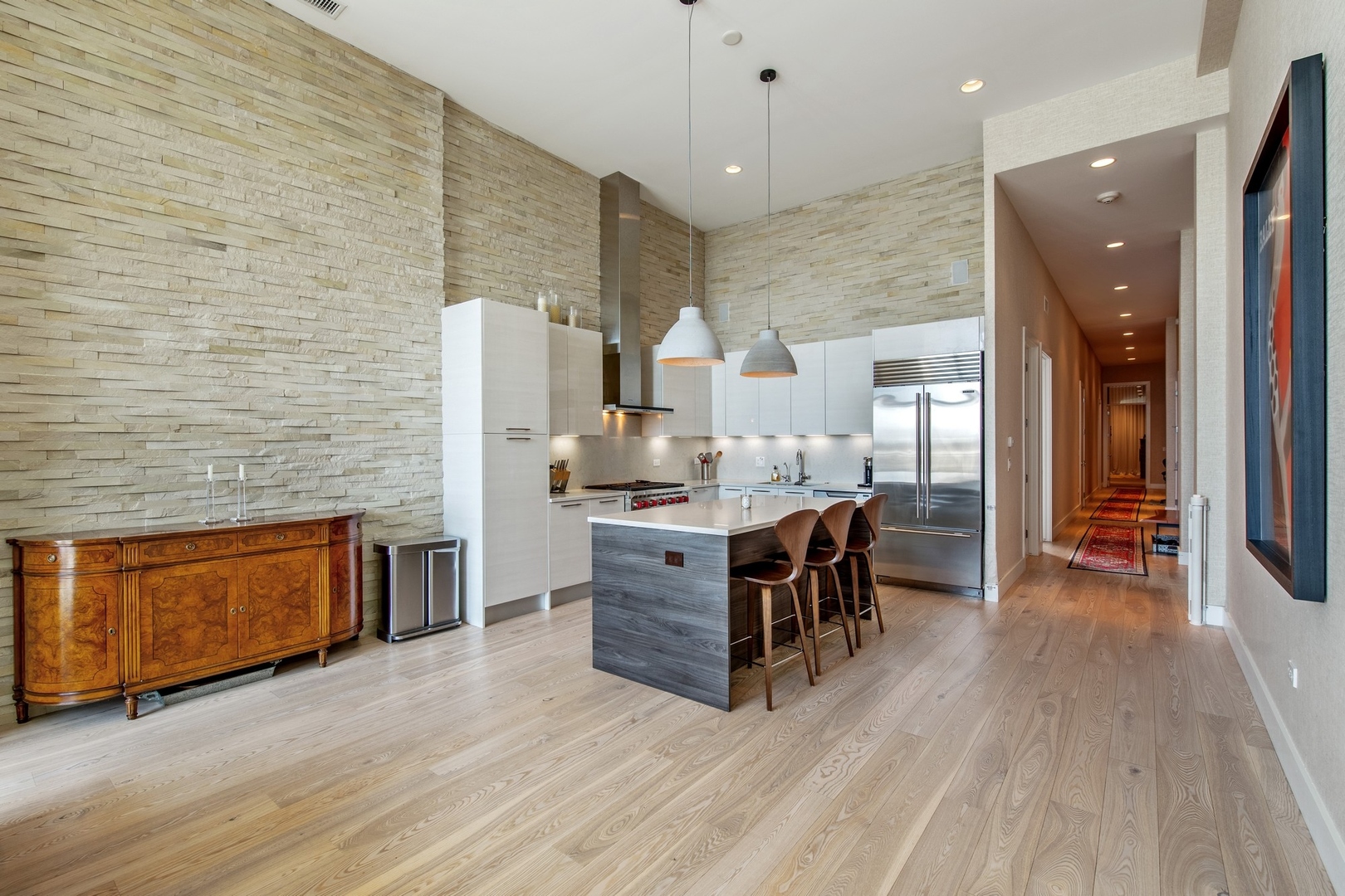1124 West Adams Street, Unit PHW Chicago, IL 60607 - Photo 6 of 55 a kitchen with stainless steel appliances granite countertop a sink a stove and a wooden floors