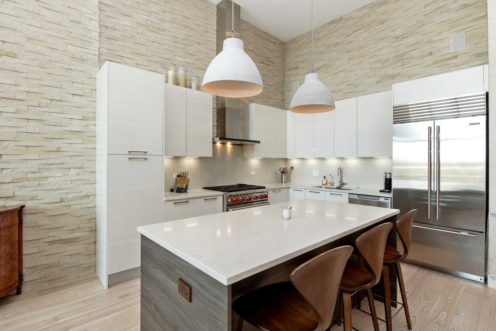 1124 West Adams Street, Unit PHW Chicago, IL 60607 - Photo 7 of 55 a kitchen with stainless steel appliances a sink a stove a refrigerator cabinets and wooden floor