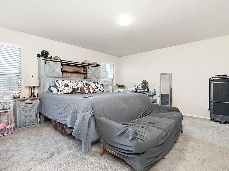 2320 Willard Way Forney, TX 75126 - Photo 14 of 26 a bedroom with a bed and wooden floor