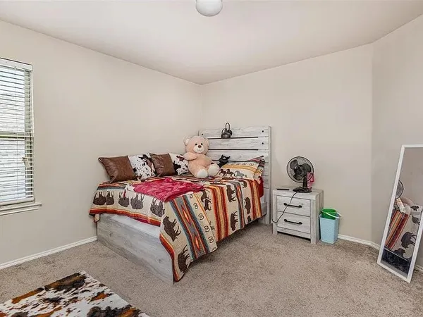 a bedroom with a bed and a window