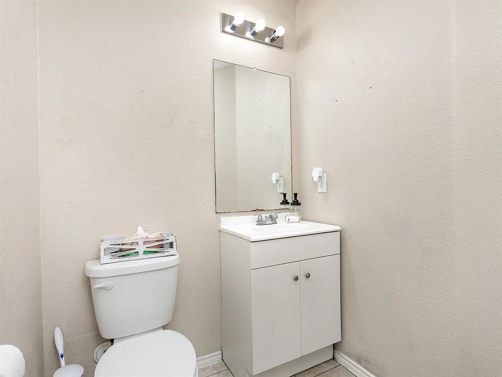 2320 Willard Way Forney, TX 75126 - Photo 23 of 26 a bathroom with a toilet sink and mirror