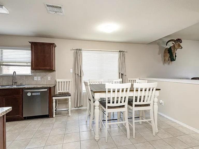 2320 Willard Way Forney, TX 75126 - Photo 9 of 26 a dining room with furniture a window and kitchen view