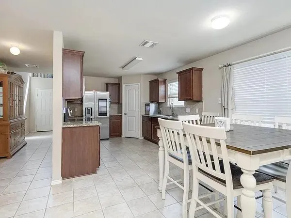 a kitchen with stainless steel appliances granite countertop a refrigerator and a stove top oven