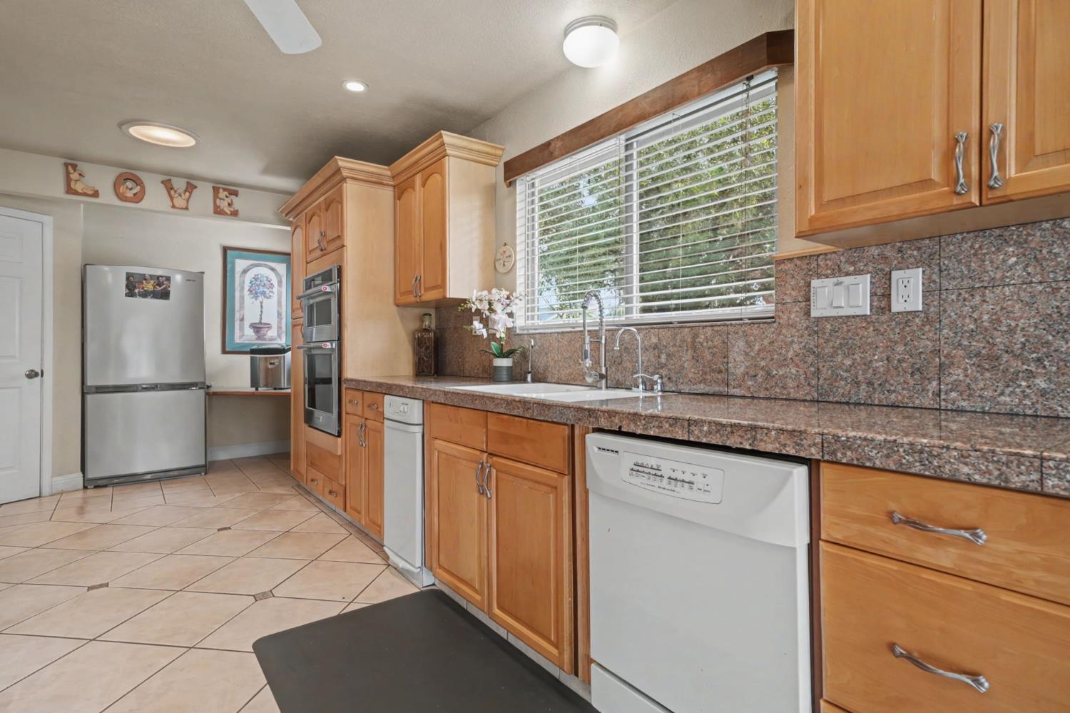 450 Lakeview Road Copperopolis, CA 95228 - Photo 26 of 93 a kitchen with stainless steel appliances granite countertop a refrigerator and a sink
