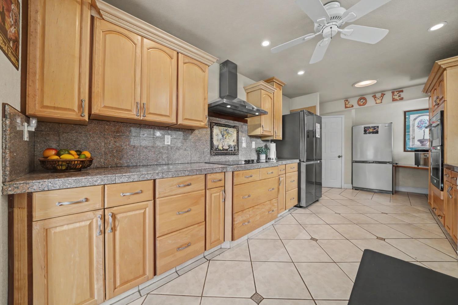 450 Lakeview Road Copperopolis, CA 95228 - Photo 27 of 93 a kitchen with white cabinets and chandelier