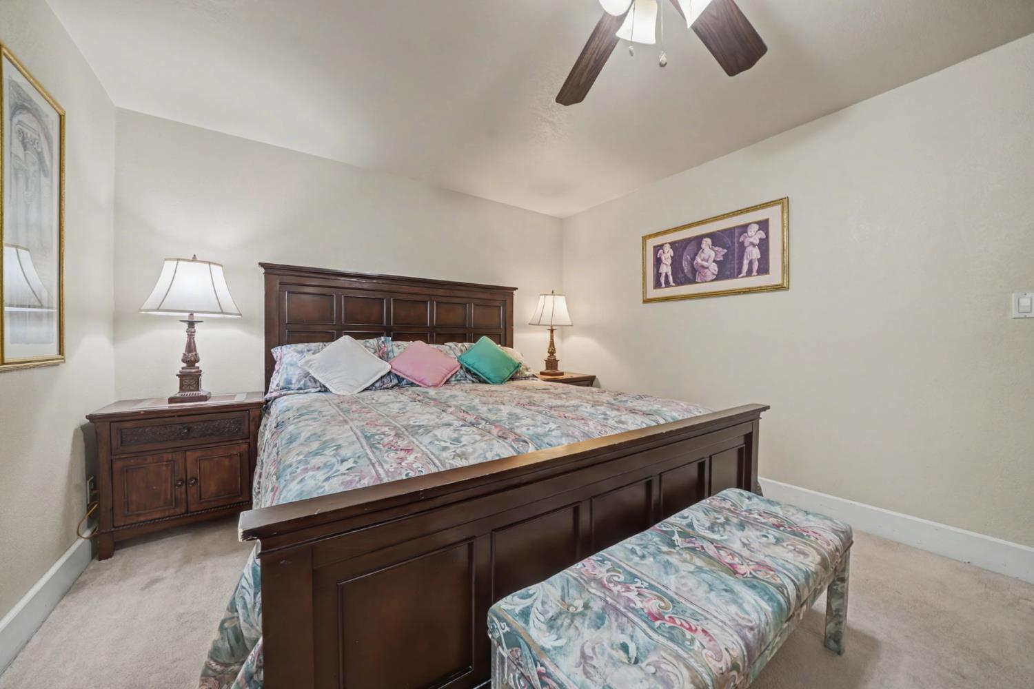 450 Lakeview Road Copperopolis, CA 95228 - Photo 39 of 93 a bedroom with a bed and a lamp on dresser