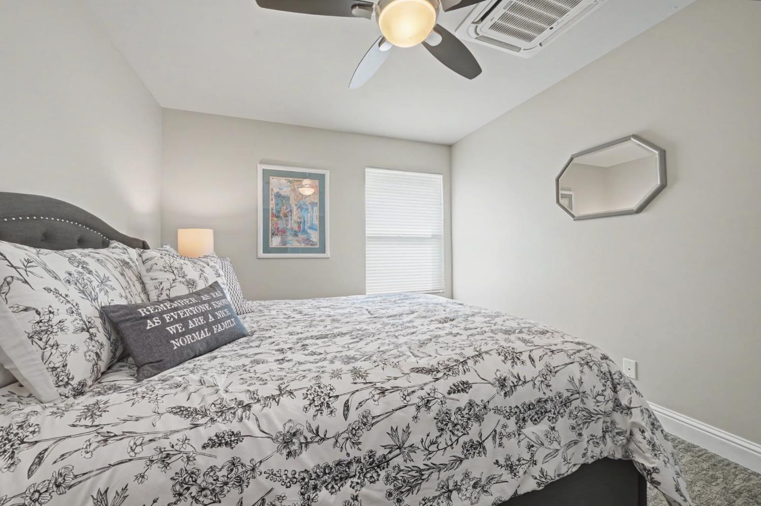 450 Lakeview Road Copperopolis, CA 95228 - Photo 55 of 93 a bedroom with a large bed and a chandelier