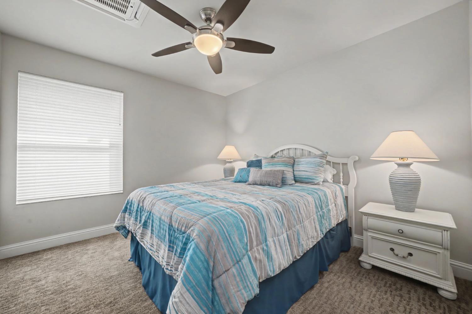 450 Lakeview Road Copperopolis, CA 95228 - Photo 58 of 93 a bedroom with two beds and a chandelier