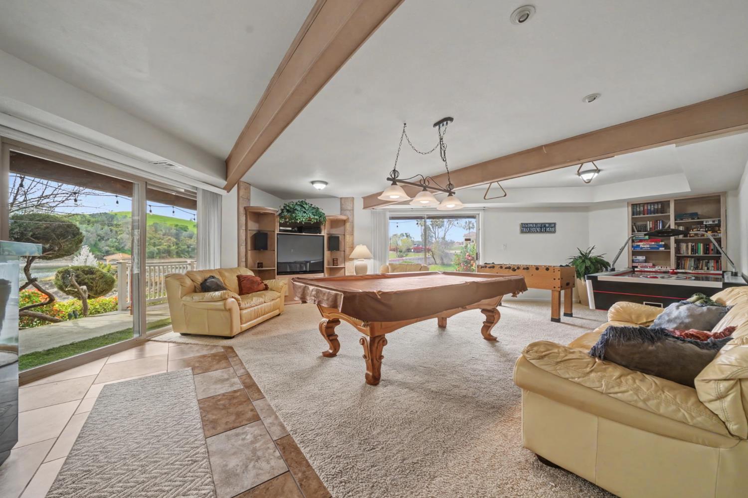 450 Lakeview Road Copperopolis, CA 95228 - Photo 68 of 93 a living room with furniture a wooden floor and a large window