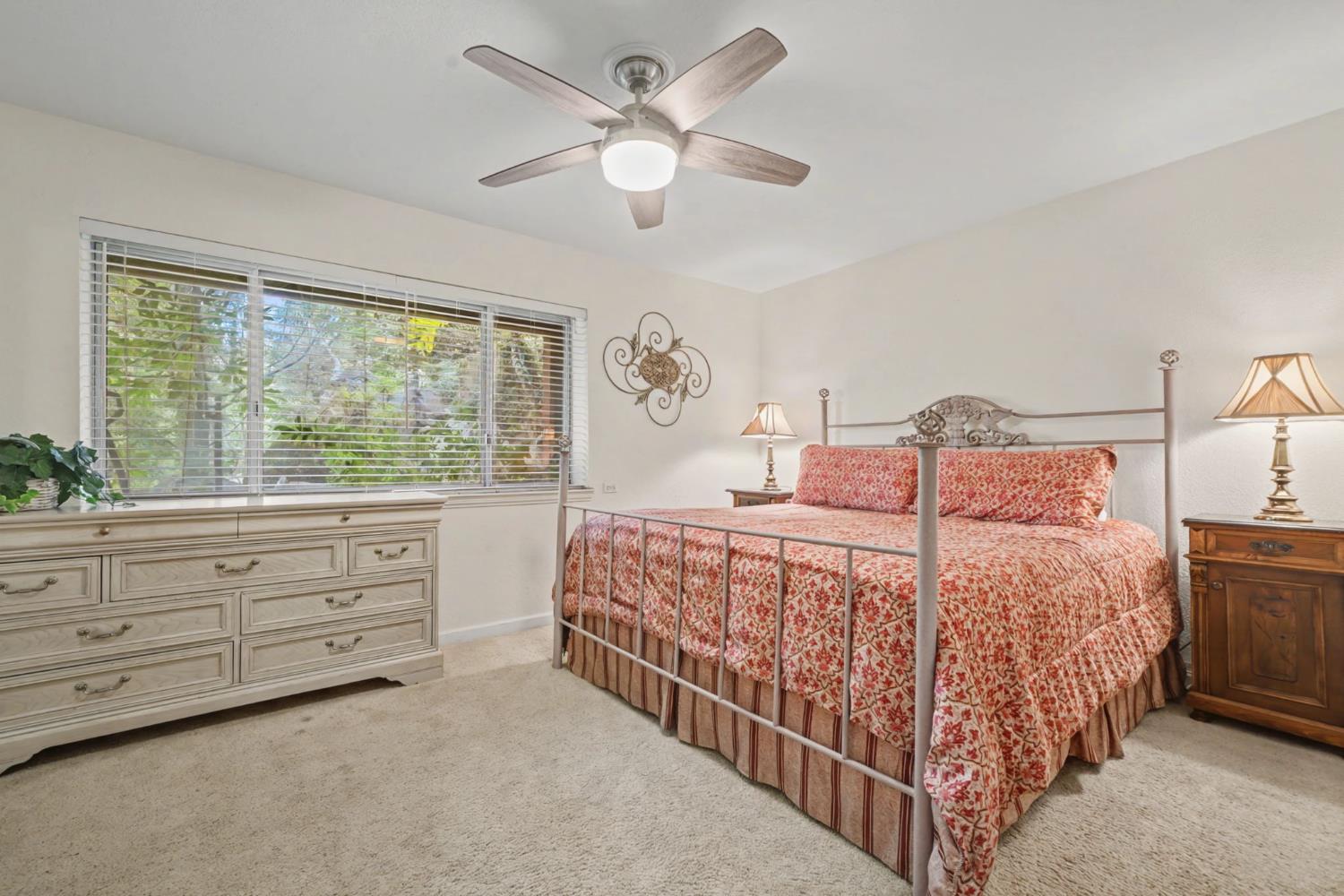 450 Lakeview Road Copperopolis, CA 95228 - Photo 76 of 93 a bedroom with a large bed and a chandelier fan