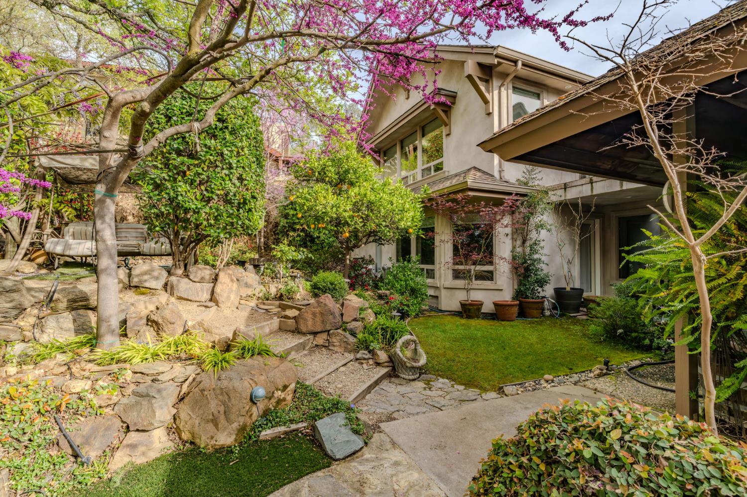 450 Lakeview Road Copperopolis, CA 95228 - Photo 80 of 93 a view of a white house with a yard and potted plants