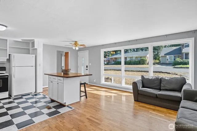 a living room with furniture and a open kitchen view