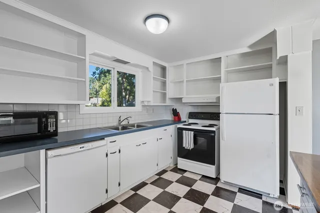 a kitchen with a sink stainless steel appliances and cabinets