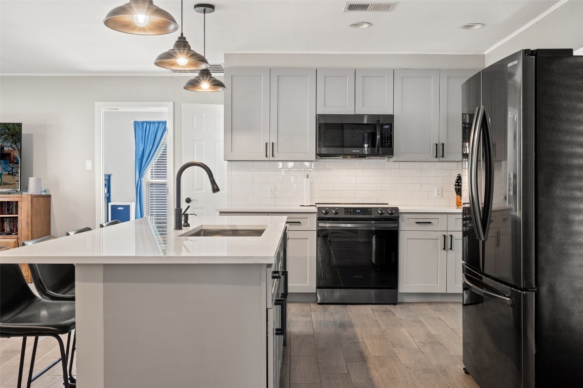 35 Presidio Road Wimberley, TX 78676 - Photo 12 of 39 a kitchen with stainless steel appliances a refrigerator sink and stove