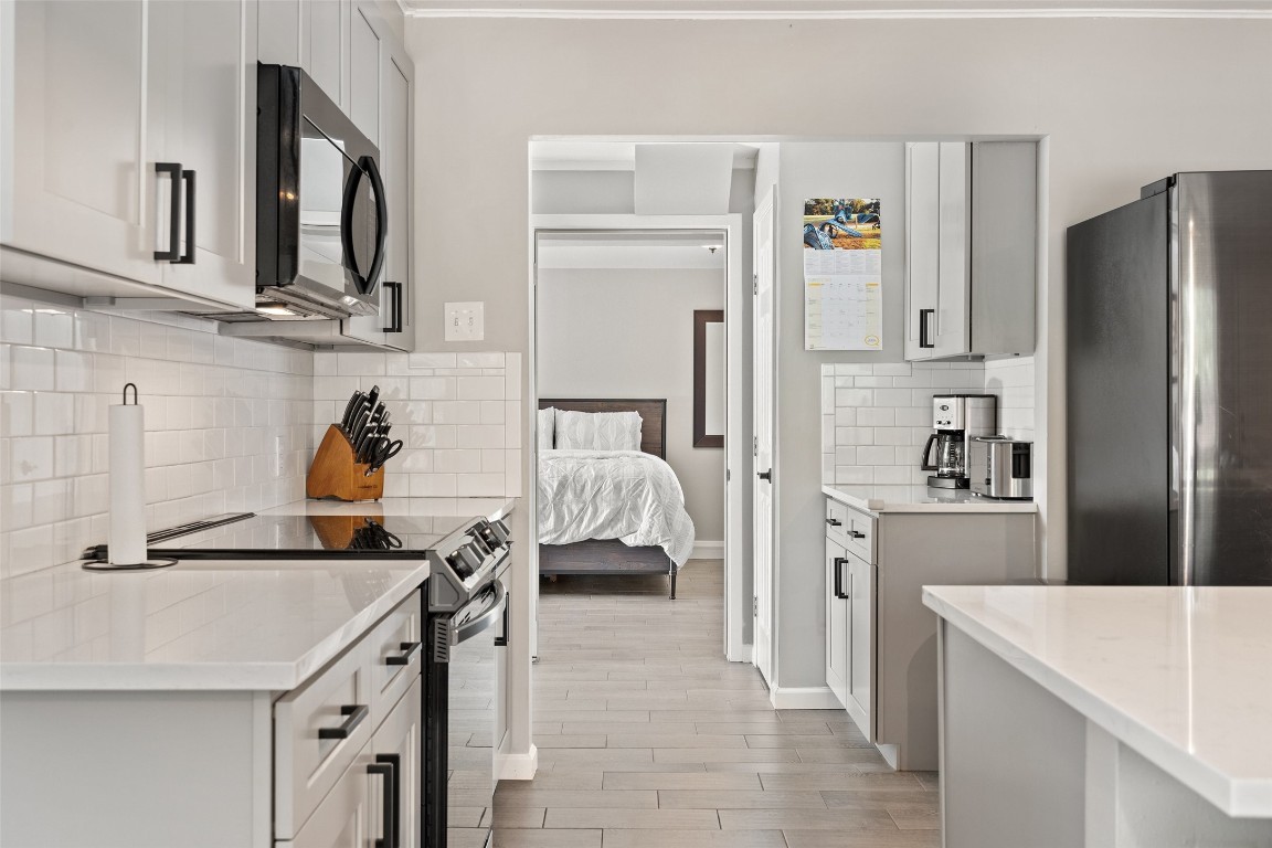 35 Presidio Road Wimberley, TX 78676 - Photo 14 of 39 a kitchen with stainless steel appliances granite countertop a refrigerator a stove and a sink