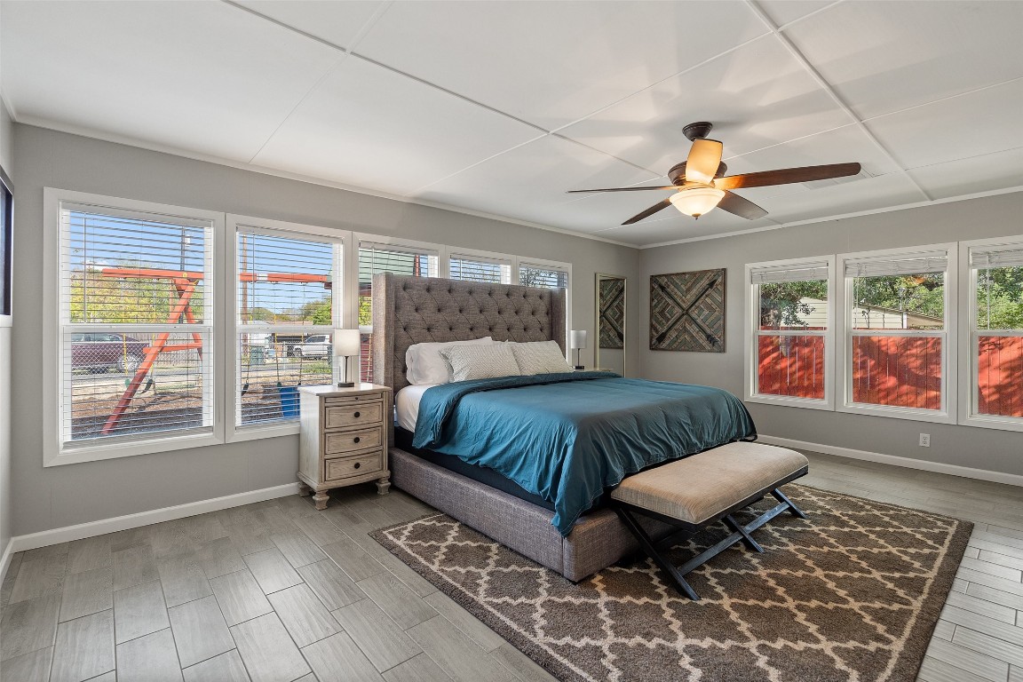 35 Presidio Road Wimberley, TX 78676 - Photo 18 of 39 a spacious bedroom with a bed and a large window