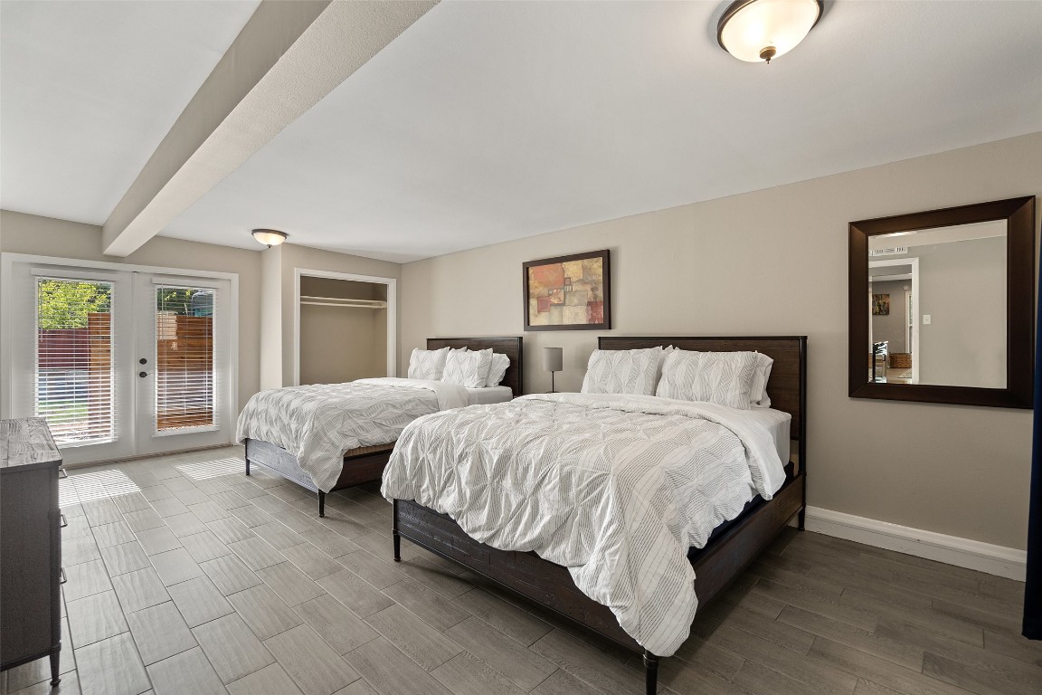 35 Presidio Road Wimberley, TX 78676 - Photo 23 of 39 a spacious bedroom with a bed and large window
