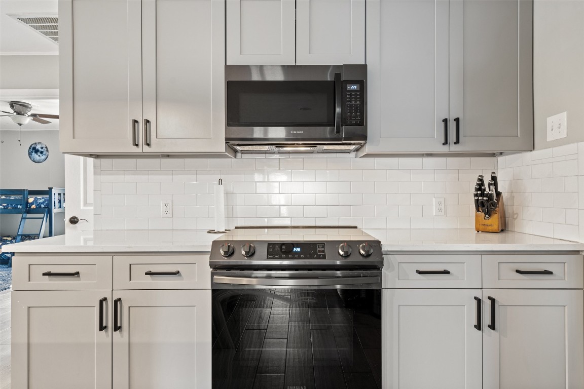 35 Presidio Road Wimberley, TX 78676 - Photo 28 of 39 a kitchen with stainless steel appliances a stove and a microwave