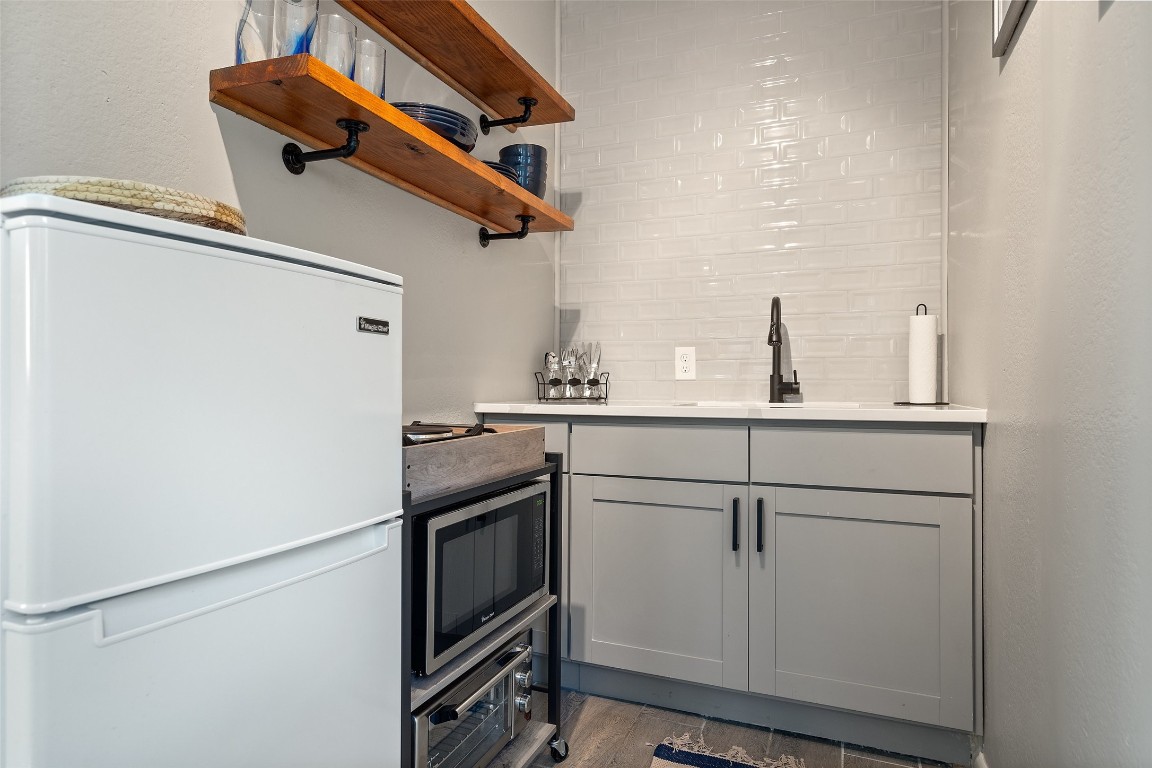 35 Presidio Road Wimberley, TX 78676 - Photo 35 of 39 a kitchen with a sink and cabinets