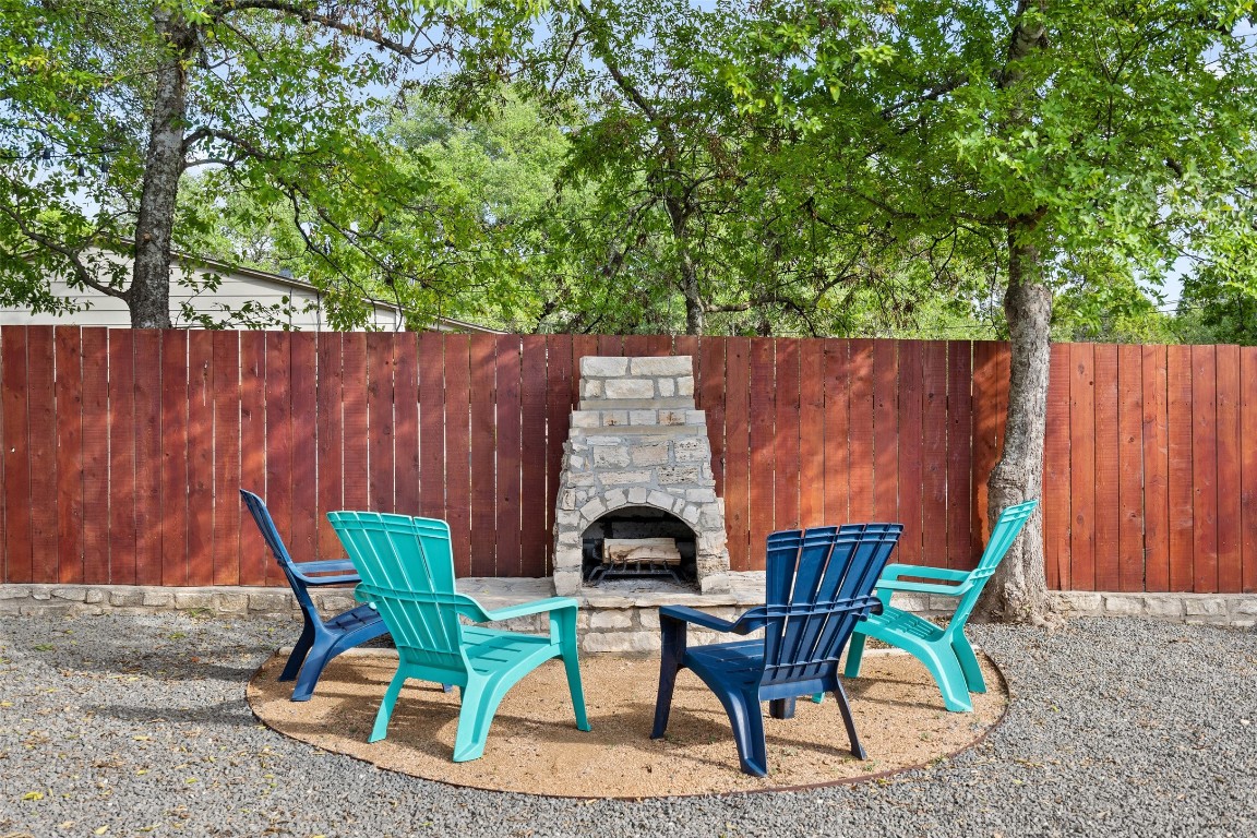 35 Presidio Road Wimberley, TX 78676 - Photo 8 of 39 a backyard of a house with table and chairs