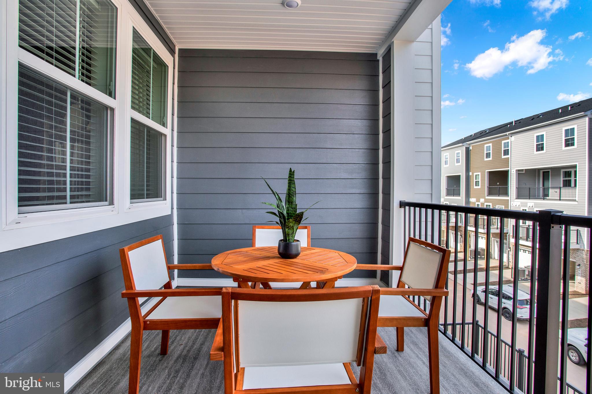 1006 Swallowtail Lane Manassas, VA 20110 - Photo 14 of 65 a wooden table and chairs in a balcony