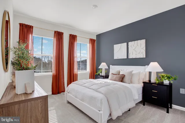 a bedroom with bed and large windows