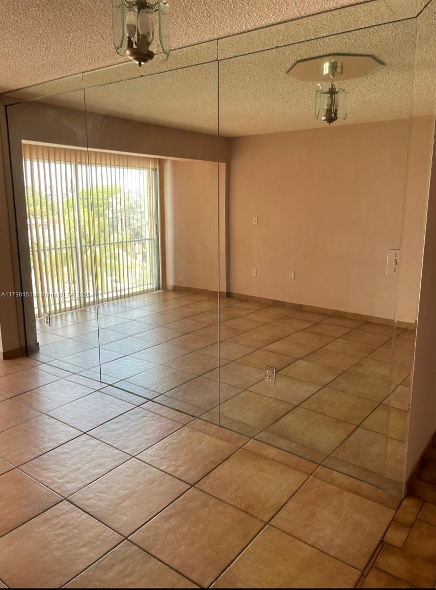 1793 Southwest 5th Street, Unit 401 Miami, FL 33135 - Photo 2 of 12 a view of a livingroom with wooden floor and a window
