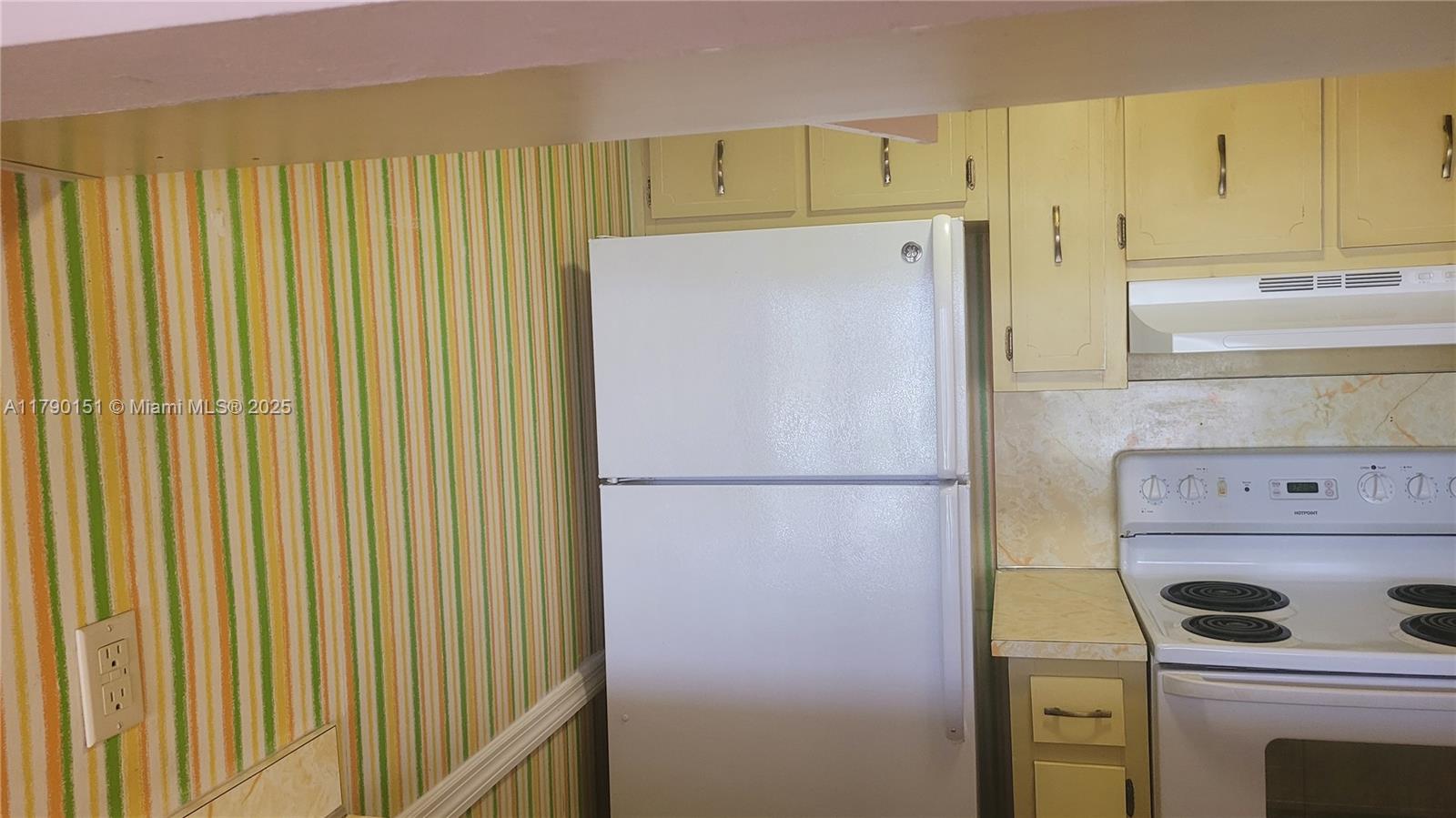 1793 Southwest 5th Street, Unit 401 Miami, FL 33135 - Photo 4 of 12 a white refrigerator freezer sitting in a kitchen