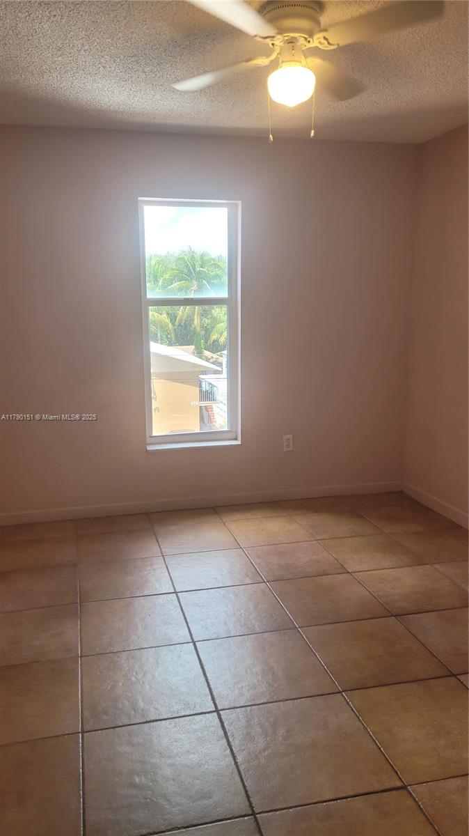 1793 Southwest 5th Street, Unit 401 Miami, FL 33135 - Photo 5 of 12 a view of an empty room with a window