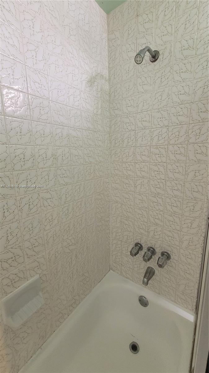 1793 Southwest 5th Street, Unit 401 Miami, FL 33135 - Photo 9 of 12 a bathroom with a bathtub