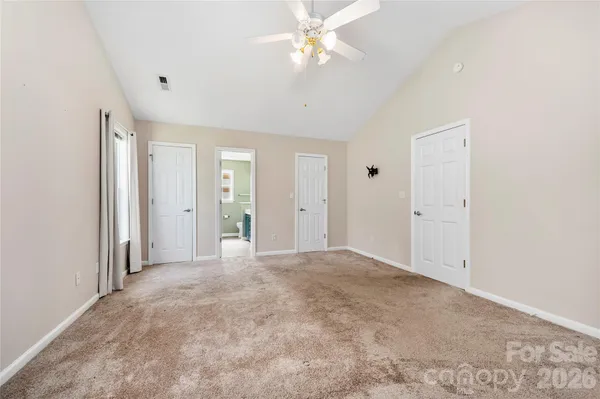 an empty room with fan and entrance