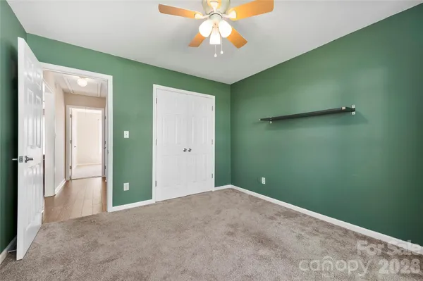 a view of a room with a fan and closet