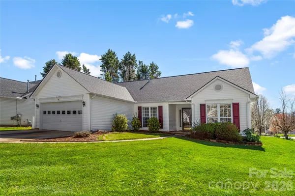 a front view of house with yard and green space