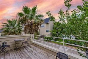 896 Davis Road League City, TX 77573 - Photo 14 of 46 a view of a roof deck with table and chairs with wooden floor and fence