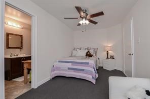 896 Davis Road League City, TX 77573 - Photo 33 of 46 a bedroom with a bed and a chandelier