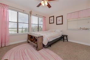 896 Davis Road League City, TX 77573 - Photo 38 of 46 a bedroom with a bed and a large window